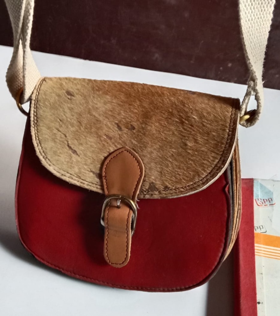 Hair-On Cowhide & Crimson Leather Saddle Bag